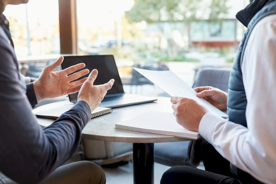 Hands discussing ERP licensing and consulting costs