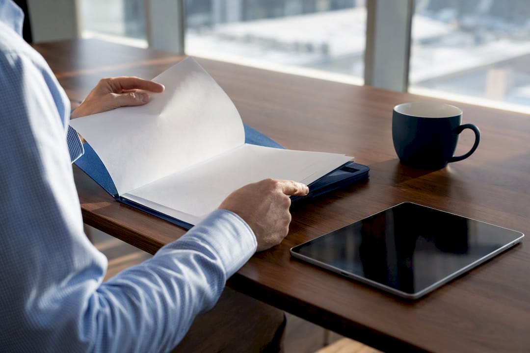 Hands pointing at accounting standards paperwork