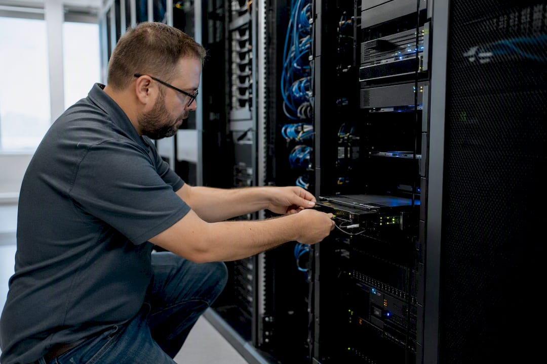 Technician manually testing backup restore in server room