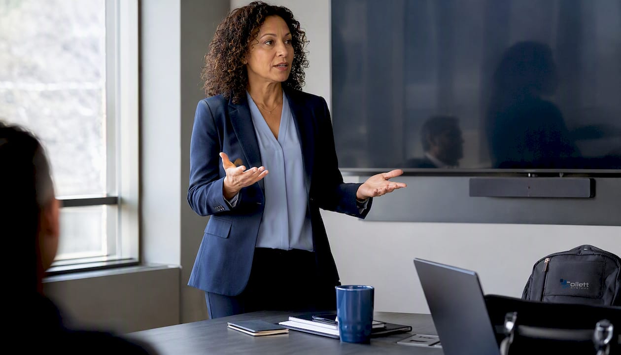 Woman reviewing phishing training report at desk